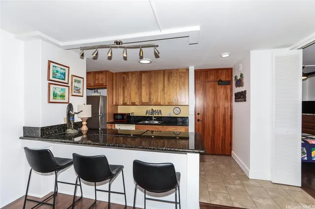 a kitchen with a sink a stove and a wooden cabinets