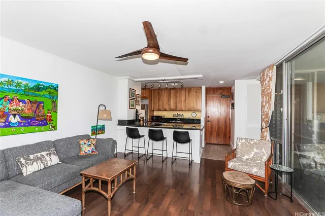 a living room with furniture a window and a flat screen tv