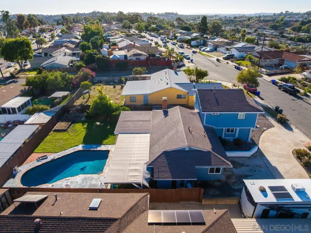 a view of a house with pool and a yard