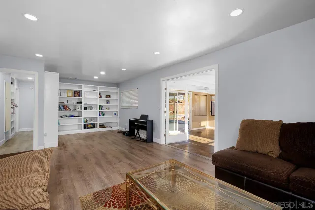 a living room with furniture and large windows