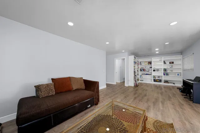 a bedroom with furniture and a wooden floor