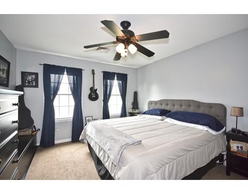 18 Terrace Street Fall River, MA 02721 - Photo 6 of 9 a bedroom with a bed and a chandelier