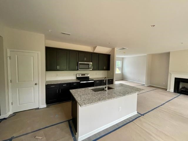 296 Great Pine Trail Middlesex, NC 27557 - Photo 3 of 16 a kitchen with stainless steel appliances granite countertop a sink stove and cabinets