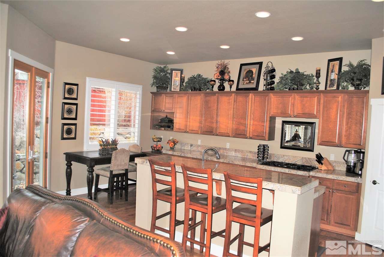 4950 Turning Leaf Way Reno, NV 89519 - Photo 4 of 11 a kitchen with stainless steel appliances granite countertop a stove a sink and a refrigerator