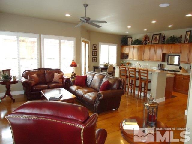 4950 Turning Leaf Way Reno, NV 89519 - Photo 5 of 11 a living room with furniture a large window and a chandelier
