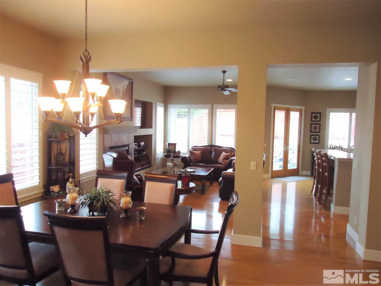 4950 Turning Leaf Way Reno, NV 89519 - Photo 7 of 11 a dining room with furniture a chandelier and wooden floor