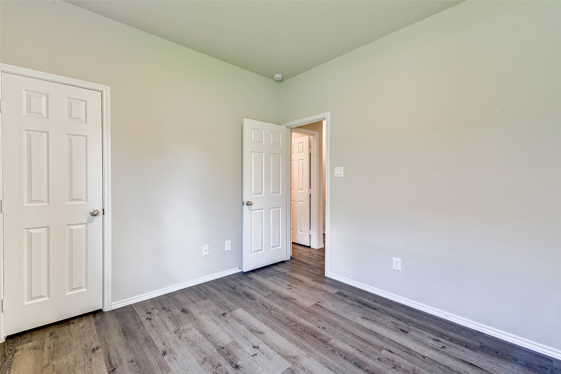 409 East Avenue G Conroe, TX 77301 - Photo 12 of 22 a view of an empty room and wooden floor