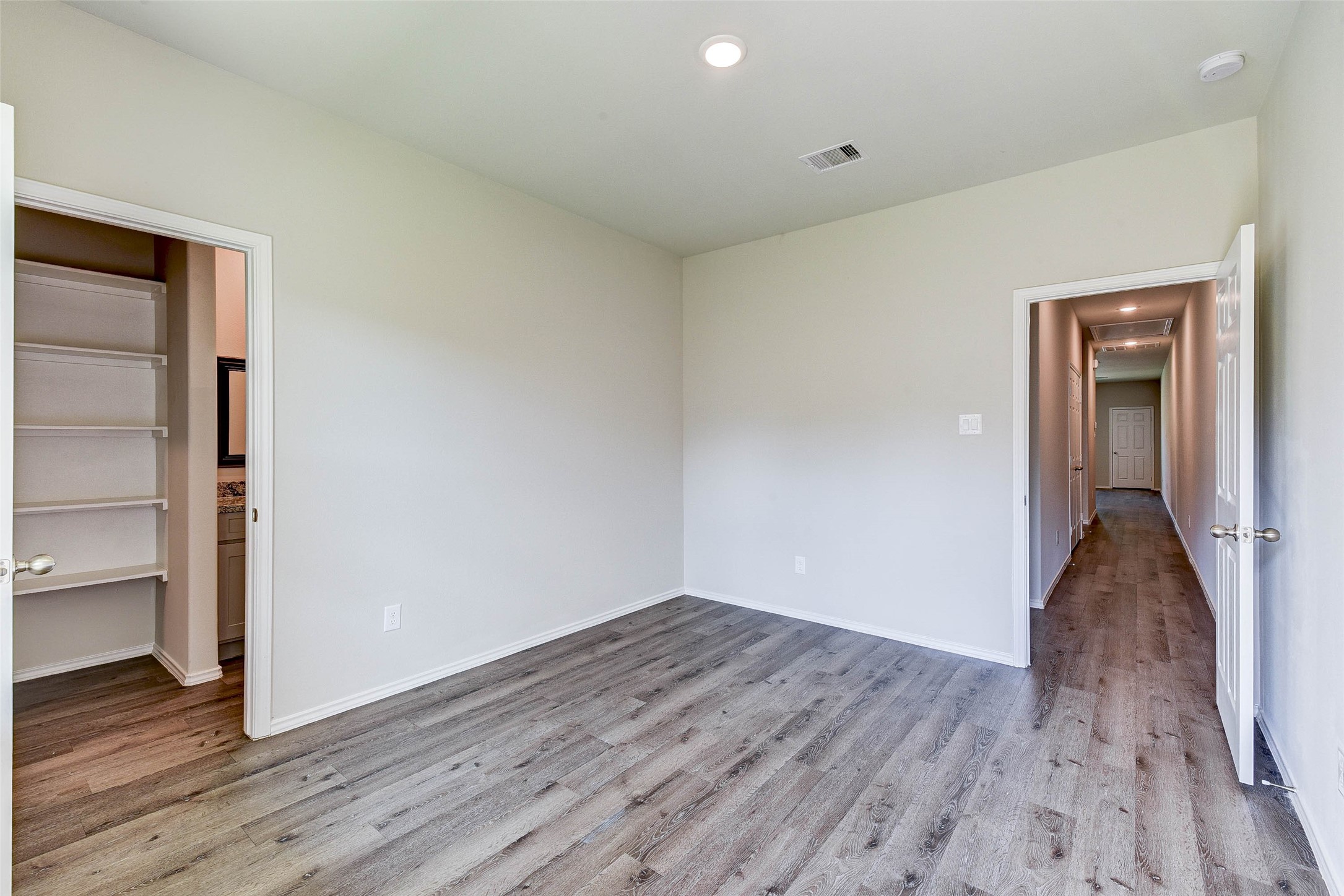 409 East Avenue G Conroe, TX 77301 - Photo 16 of 22 wooden floor in an empty room with a window