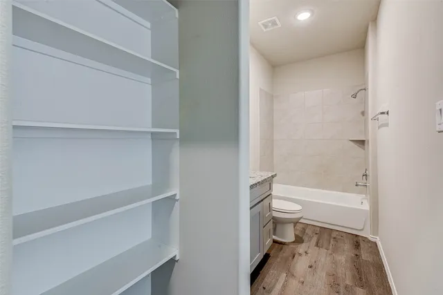 a bathroom with a toilet and a shower