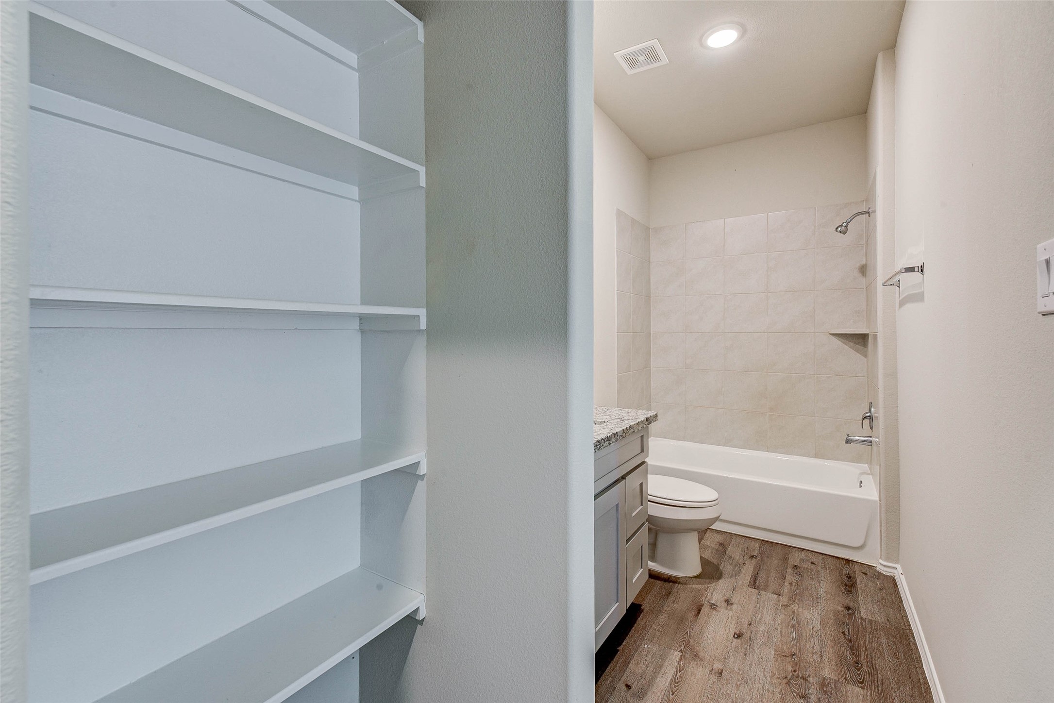 409 East Avenue G Conroe, TX 77301 - Photo 17 of 22 a bathroom with a toilet and a shower
