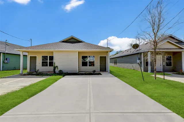 a front view of a house with a yard and porch
