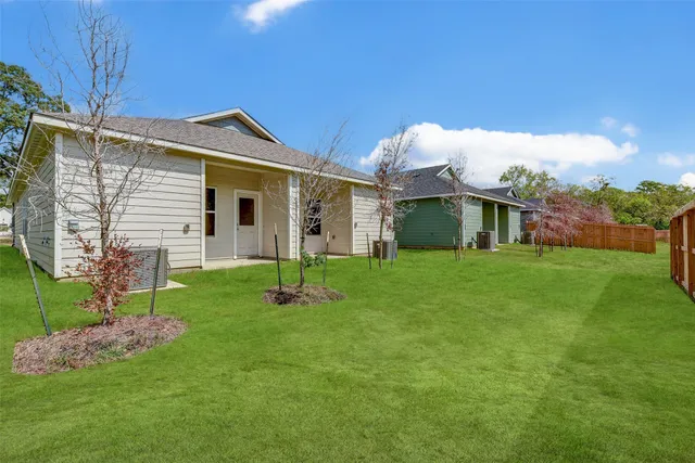 a front view of house with a garden