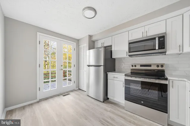 a kitchen with a refrigerator stove and microwave