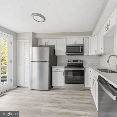 a kitchen with a refrigerator stove and microwave