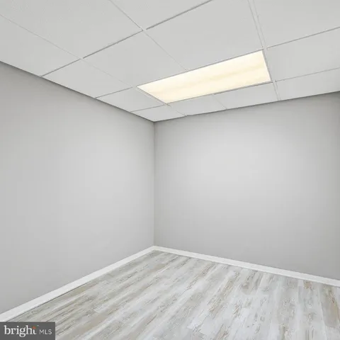 a utility room with a sink a chair and dryer