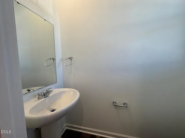 a view of a kitchen with wooden floor and electronic appliances