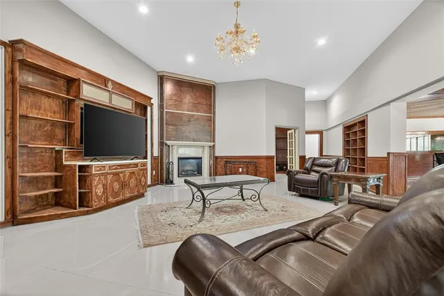 a view of a livingroom with wooden floor and a fireplace
