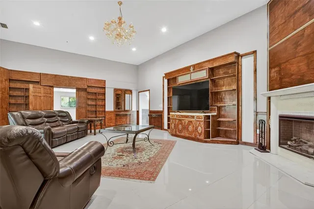 a view of a livingroom with wooden floor and a fireplace