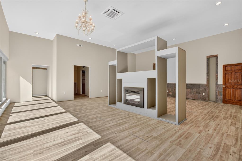 12903 112th Avenue Alachua, FL 32615 - Photo 29 of 95 a view of a livingroom with wooden floor and a fireplace