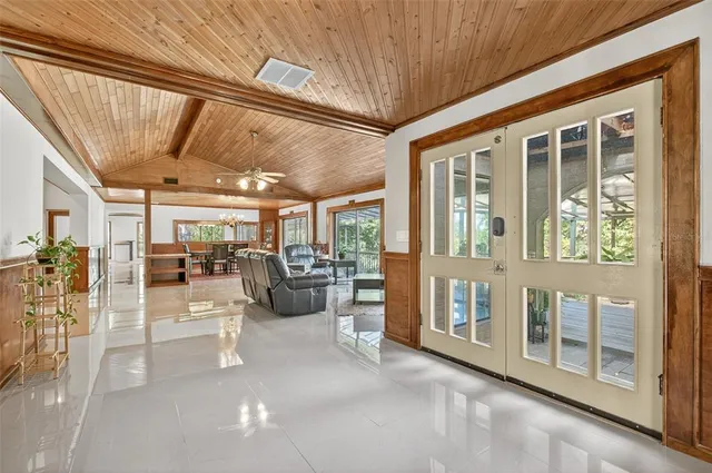 a living room with furniture and a floor to ceiling window