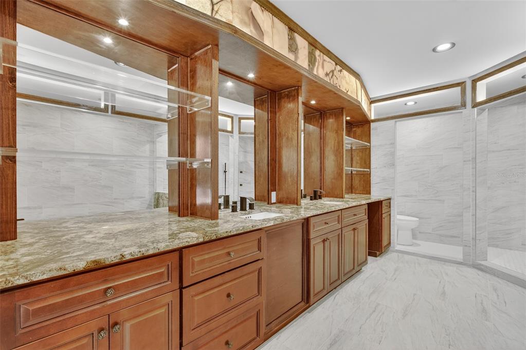 12903 112th Avenue Alachua, FL 32615 - Photo 36 of 95 a bathroom with a granite countertop sink mirror and double
