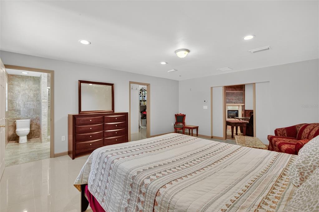 12903 112th Avenue Alachua, FL 32615 - Photo 42 of 95 a bedroom with a bed and wooden floor