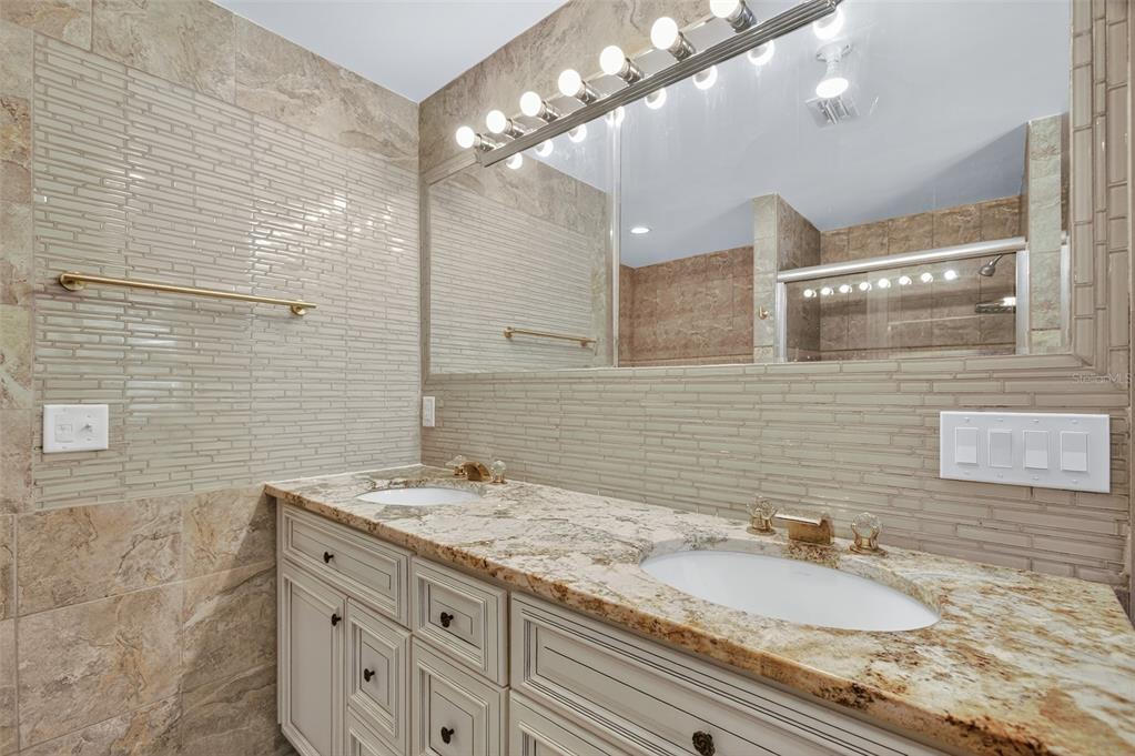 12903 112th Avenue Alachua, FL 32615 - Photo 44 of 95 a bathroom with a granite countertop double vanity and a mirror