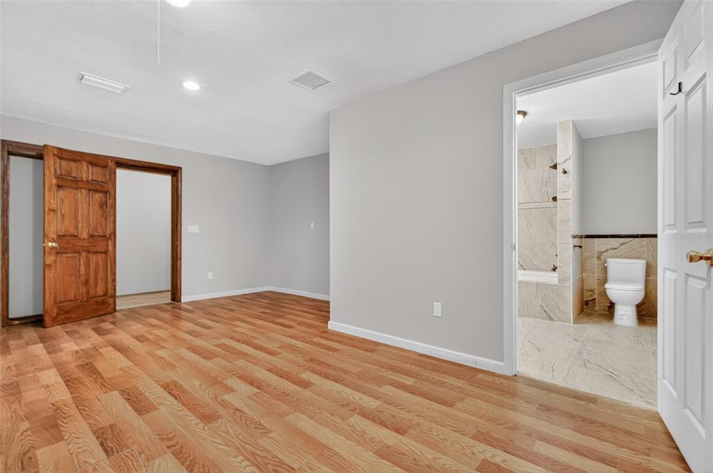 12903 112th Avenue Alachua, FL 32615 - Photo 48 of 95 a view of empty room with wooden floor and bathroom