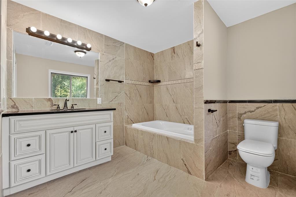 12903 112th Avenue Alachua, FL 32615 - Photo 49 of 95 a spacious bathroom with a toilet a sink and a bathtub