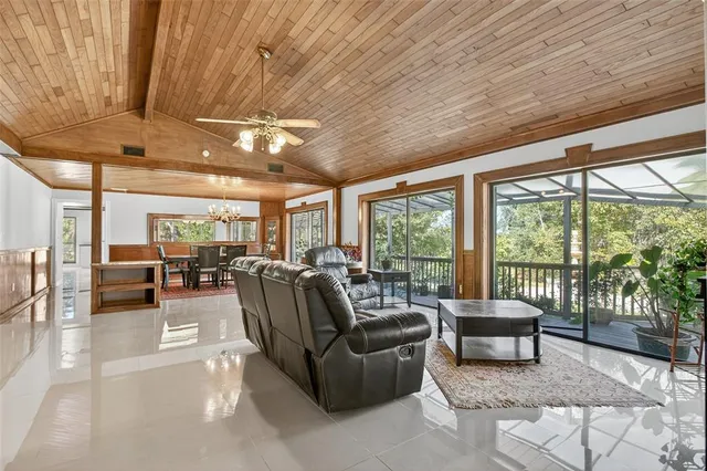 a dining room with furniture and a floor to ceiling window