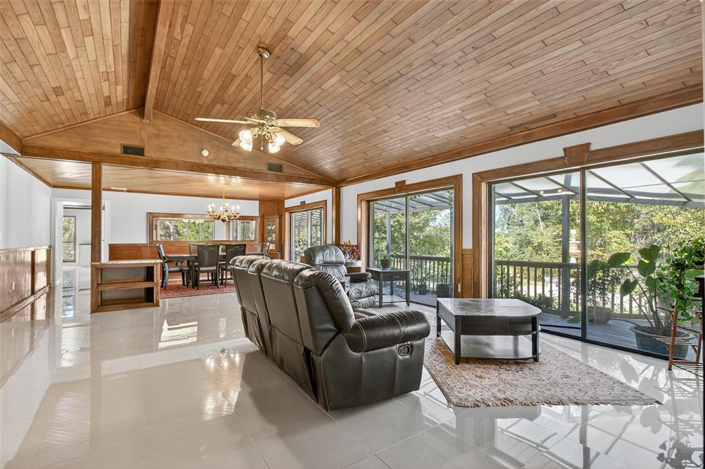 12903 112th Avenue Alachua, FL 32615 - Photo 5 of 95 a living room with furniture and a floor to ceiling window