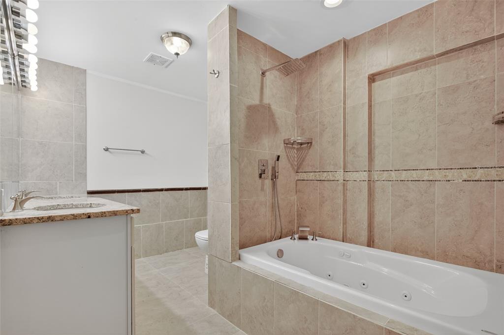 12903 112th Avenue Alachua, FL 32615 - Photo 54 of 95 a bathroom with a tub and a shower