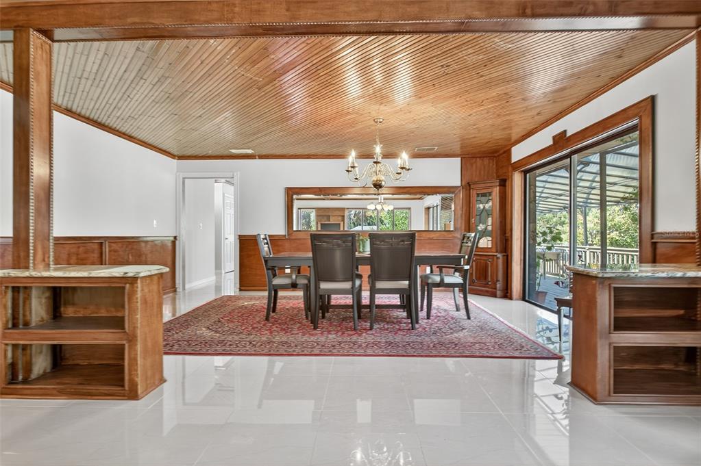 12903 112th Avenue Alachua, FL 32615 - Photo 7 of 95 a dining room with furniture and a floor to ceiling window