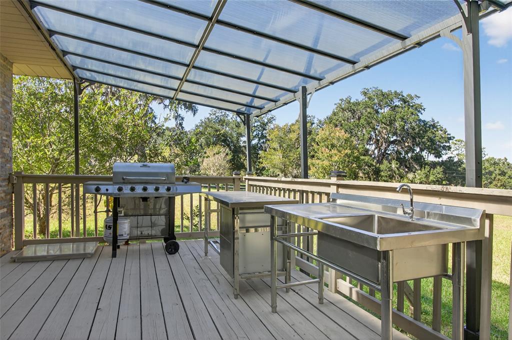12903 112th Avenue Alachua, FL 32615 - Photo 73 of 95 a view of balcony with wooden floor and iron stairs