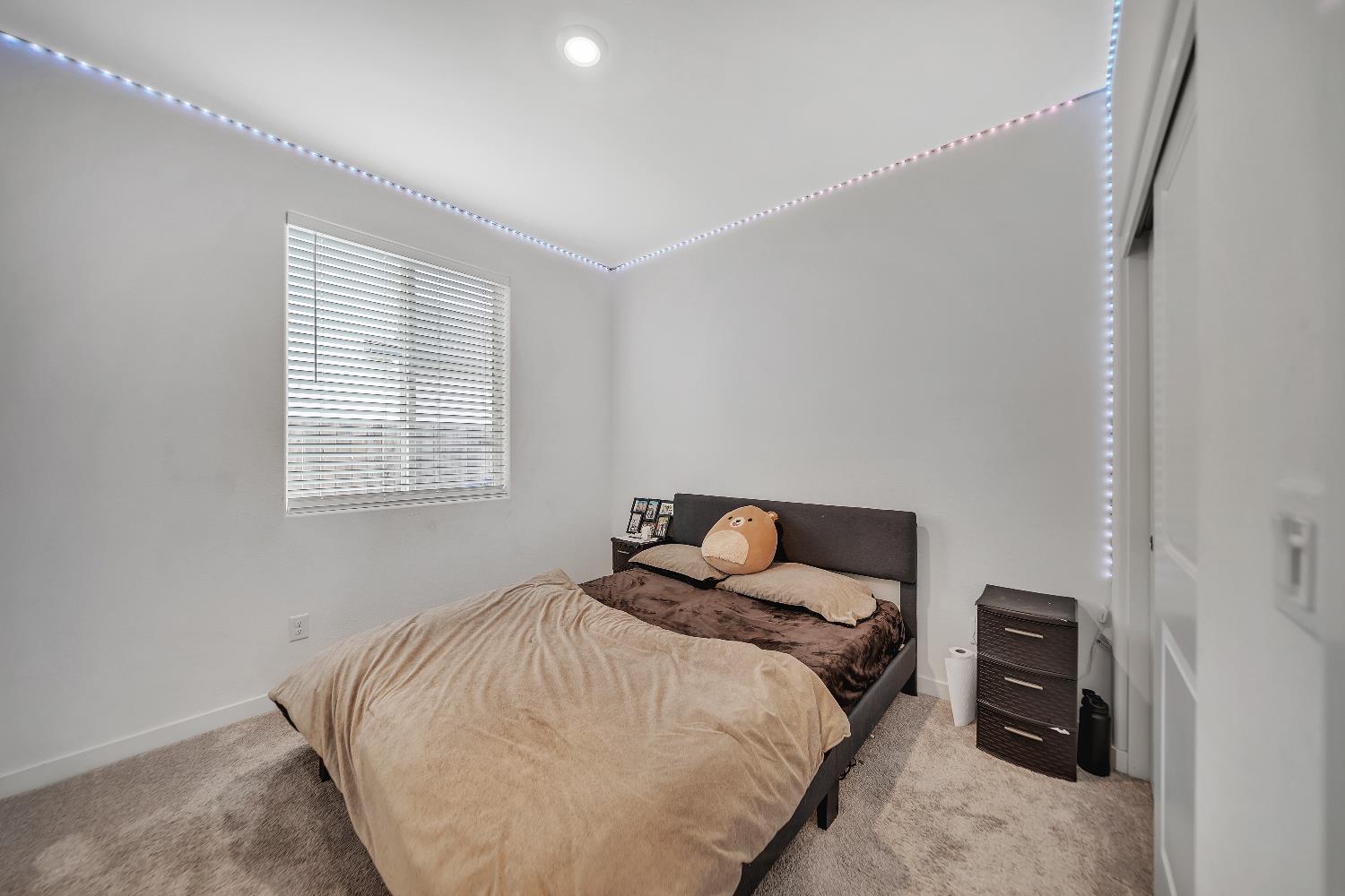 4806 Ariel Street Keyes, CA 95328 - Photo 12 of 42 a bedroom with a bed and a window