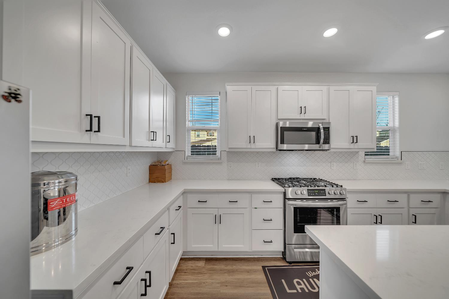 4806 Ariel Street Keyes, CA 95328 - Photo 17 of 42 a kitchen with granite countertop white cabinets and stainless steel appliances