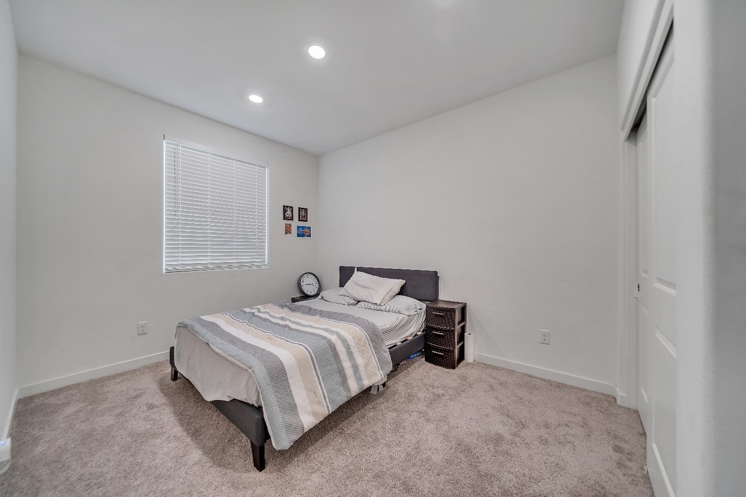 4806 Ariel Street Keyes, CA 95328 - Photo 21 of 42 a bed room with a bed and a window