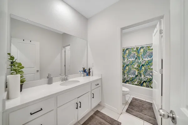 a bathroom with a sink double vanity and a mirror