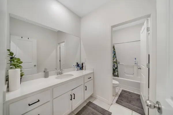 a view of a room with wooden floor and a bathroom