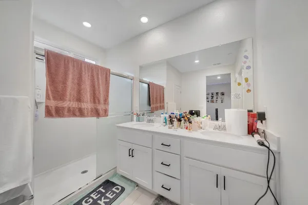 a kitchen with refrigerator and cabinets