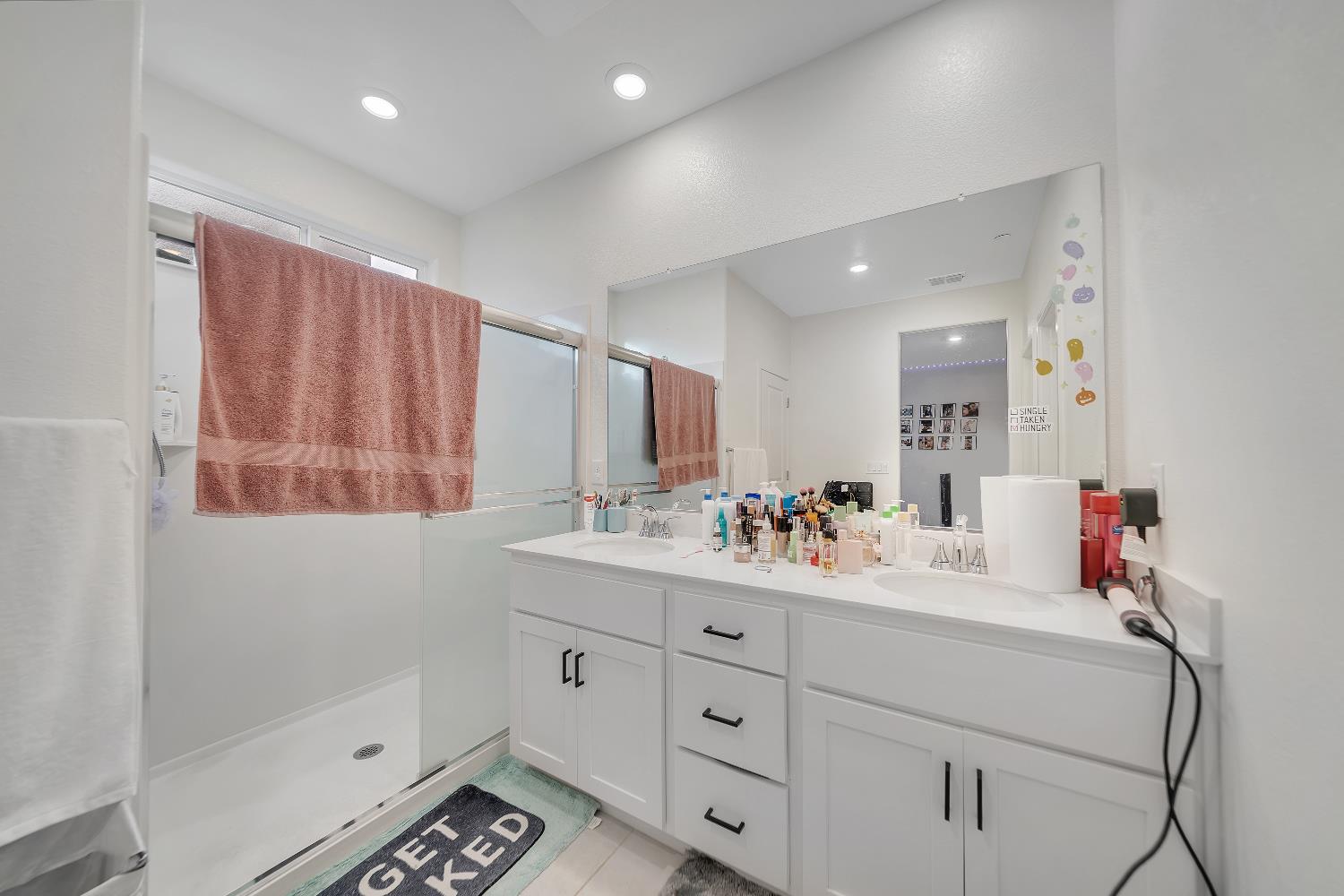 4806 Ariel Street Keyes, CA 95328 - Photo 26 of 42 a bathroom with a sink double vanity and a mirror