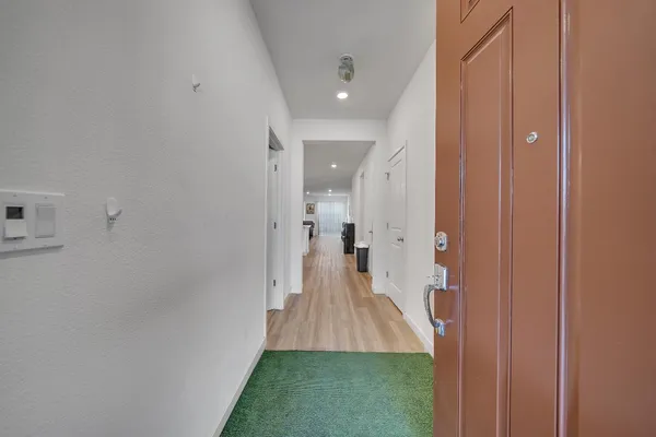 a kitchen with a sink white cabinets and stainless steel appliances