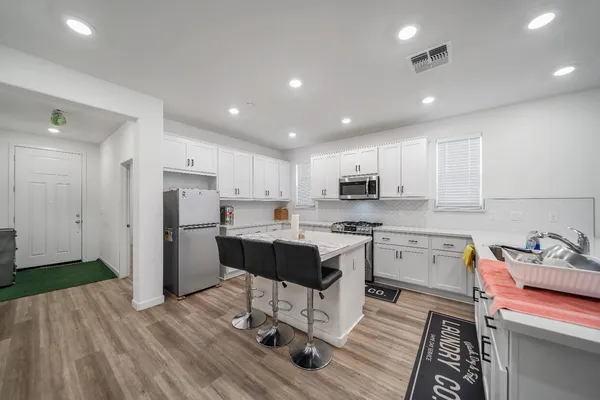 a view of a hallway with wooden floor