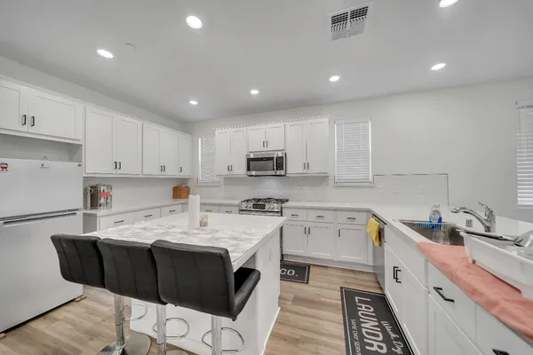 a view of a hallway with a livingroom and a bedroom