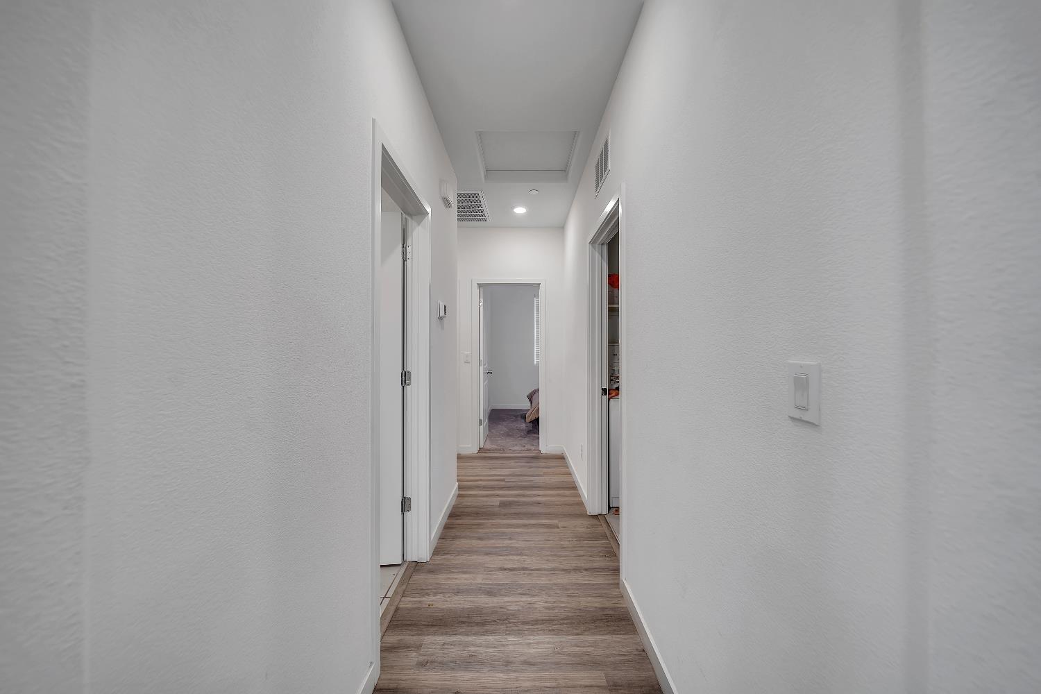 4806 Ariel Street Keyes, CA 95328 - Photo 30 of 42 a view of a hallway with wooden floor