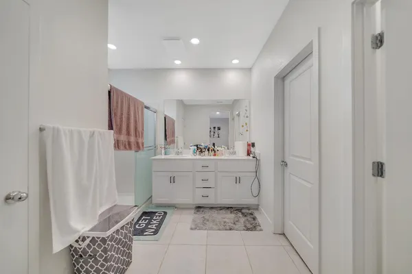 a living room with furniture wooden floor and kitchen view