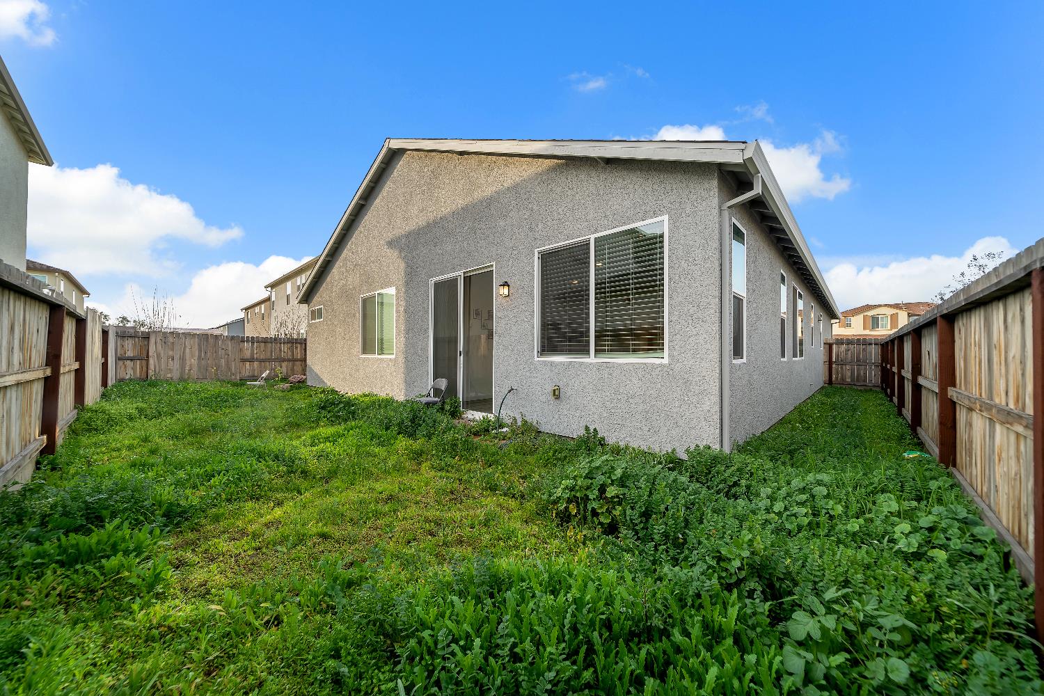 4806 Ariel Street Keyes, CA 95328 - Photo 38 of 42 a house with green field in front of it
