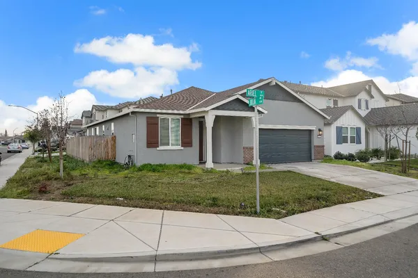 a front view of a house with a garden