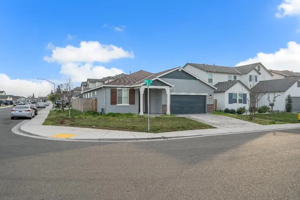 a front view of a house with a garden