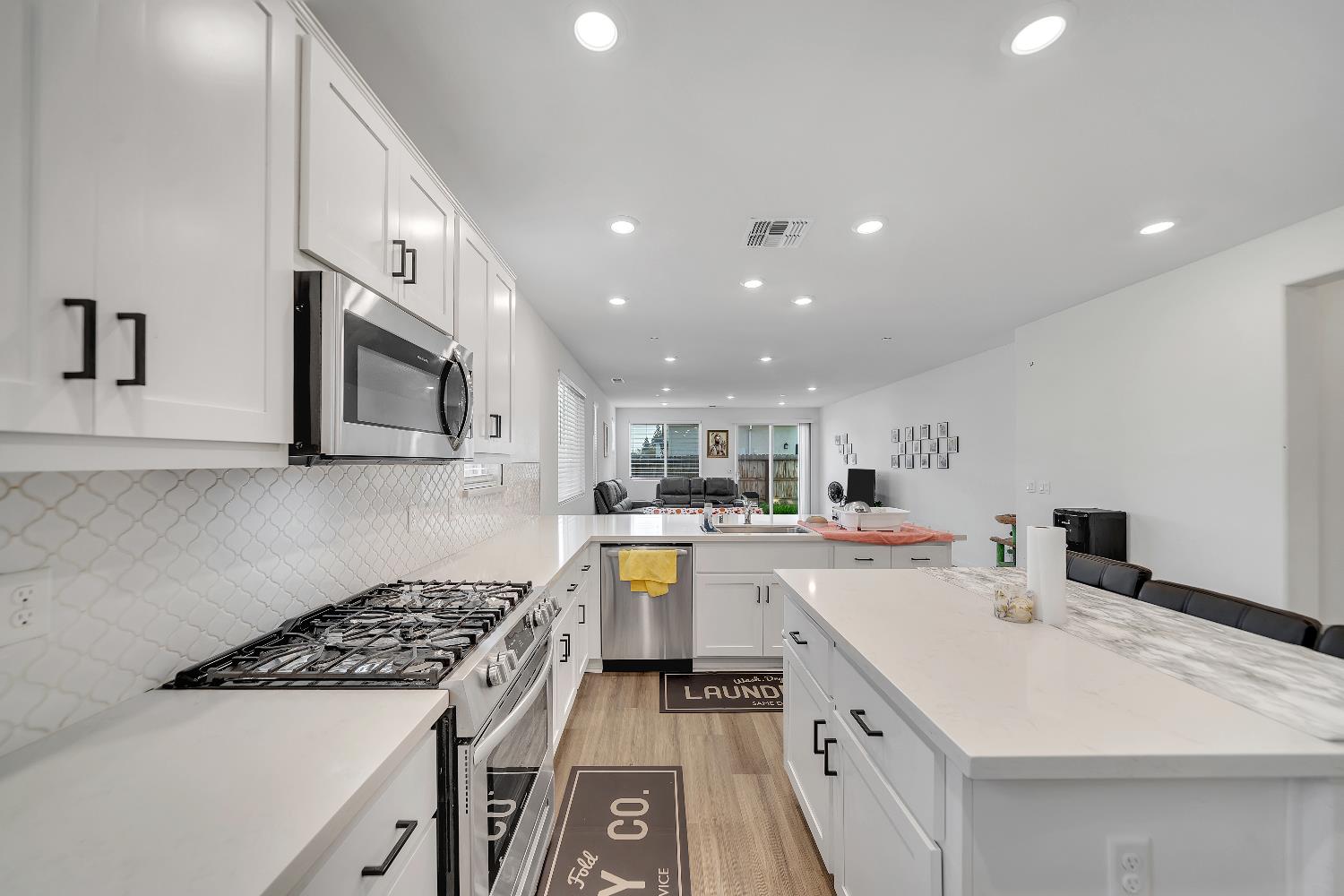 4806 Ariel Street Keyes, CA 95328 - Photo 10 of 42 a kitchen with a sink stove and microwave